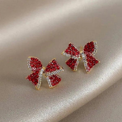Red and clear rhinestone bow earrings in gold-tone settings