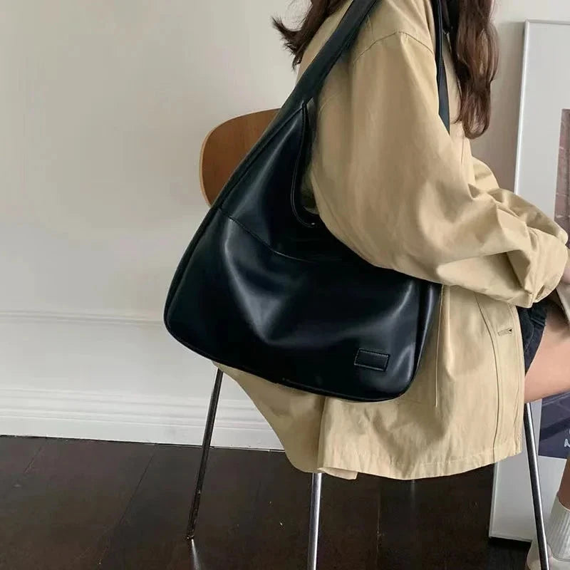 Black leather large capacity tote bag with wide shoulder straps