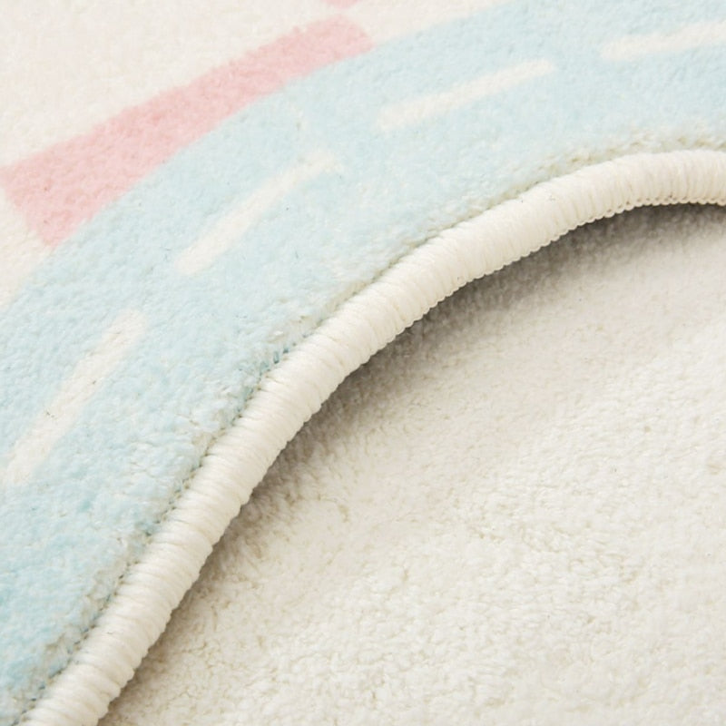 Close-up of soft rug pile and blue-trim edge on a scalloped area rug