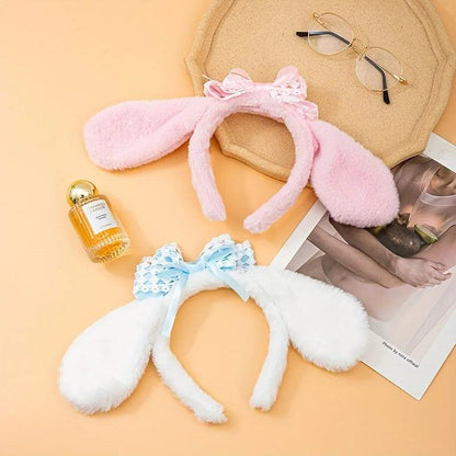 Plush bunny ear headband with pink ears, white band, and light blue lace bow.
