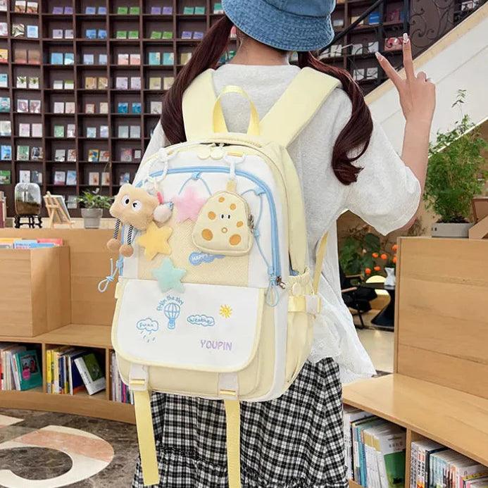 Cream and pale yellow 3-piece backpack set with character details and front flap pockets