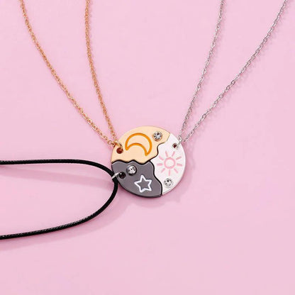 Moon-and-sun yin-yang round pendant necklace with black cord and layered gold and silver chains