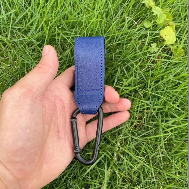 Baby stroller bag hook, blue PU leather strap with metal S-hook held in hand