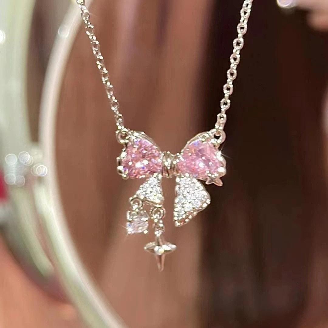 Bow pendant necklace with pink rhinestone bows and dangling star charm