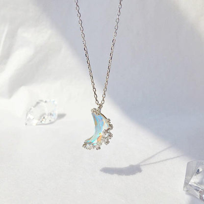 Glazed crescent moon pendant necklace with blue iridescent stone and crystal accents