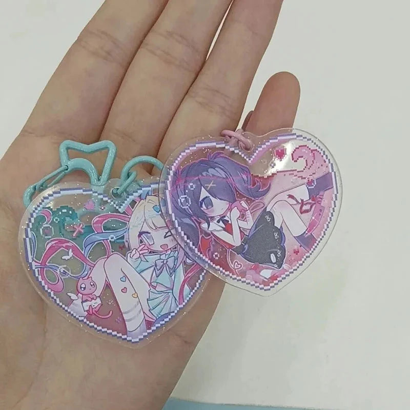 Acrylic heart keychain charms shown on an open palm, pink and teal bow details