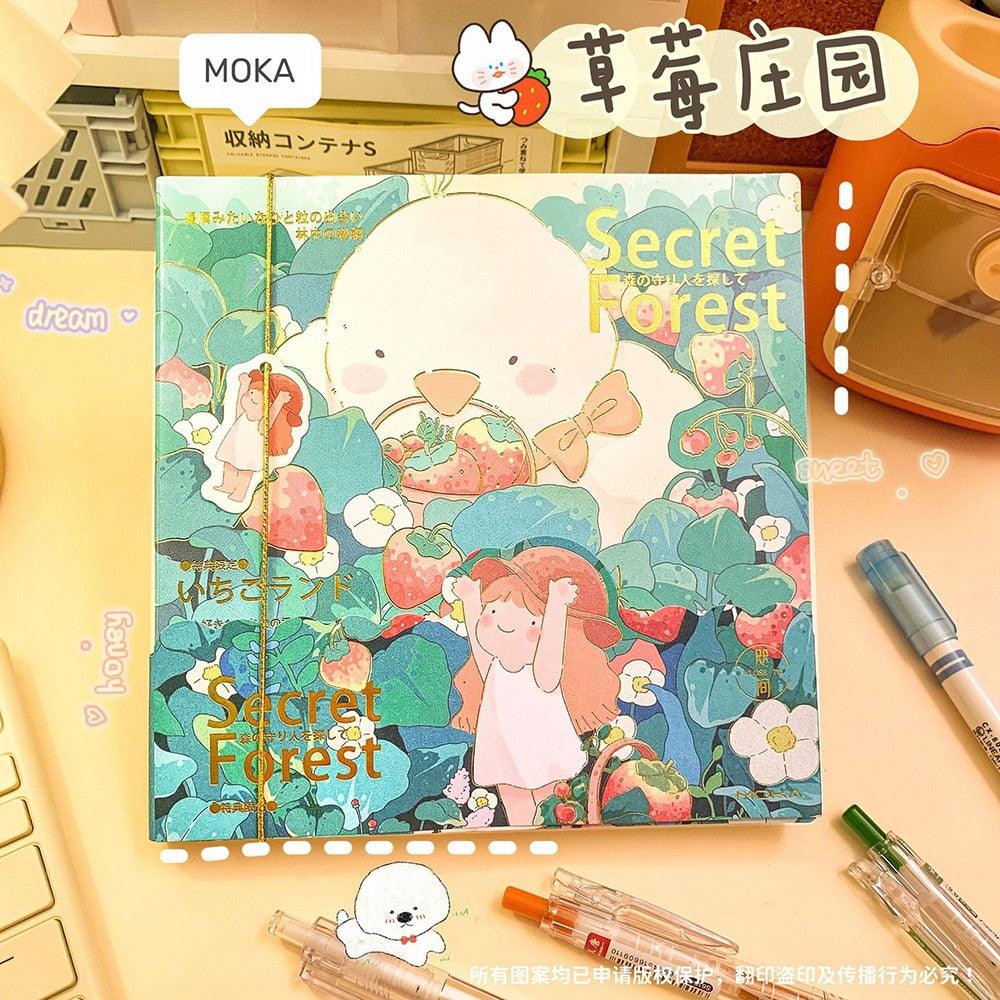 Teal illustrated notebook cover with cute animal characters and 'Secret Forest' lettering