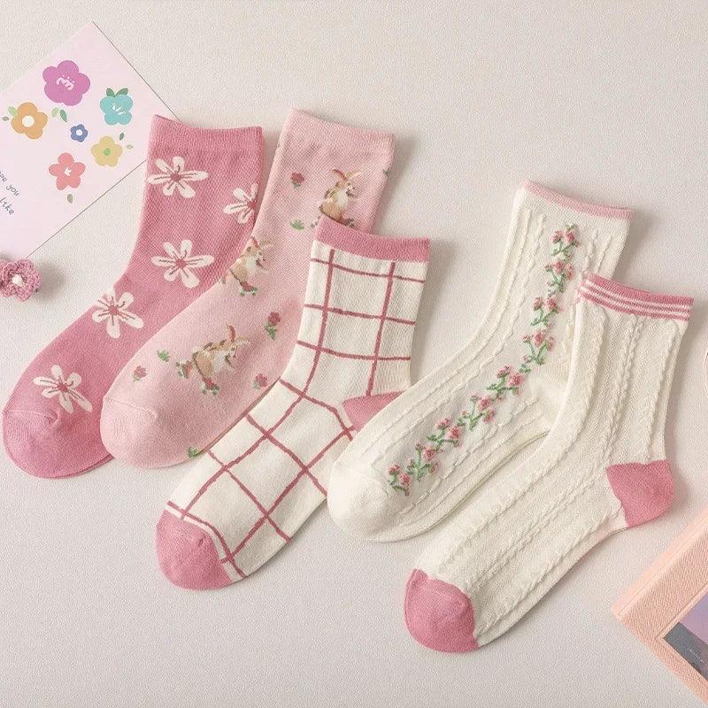 Set of pink and white floral socks with flower, bird, and plaid grid prints
