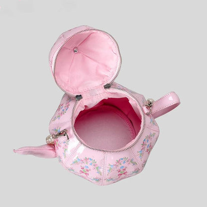 Pink teapot-shaped mini bag with open zipper top and red interior lining