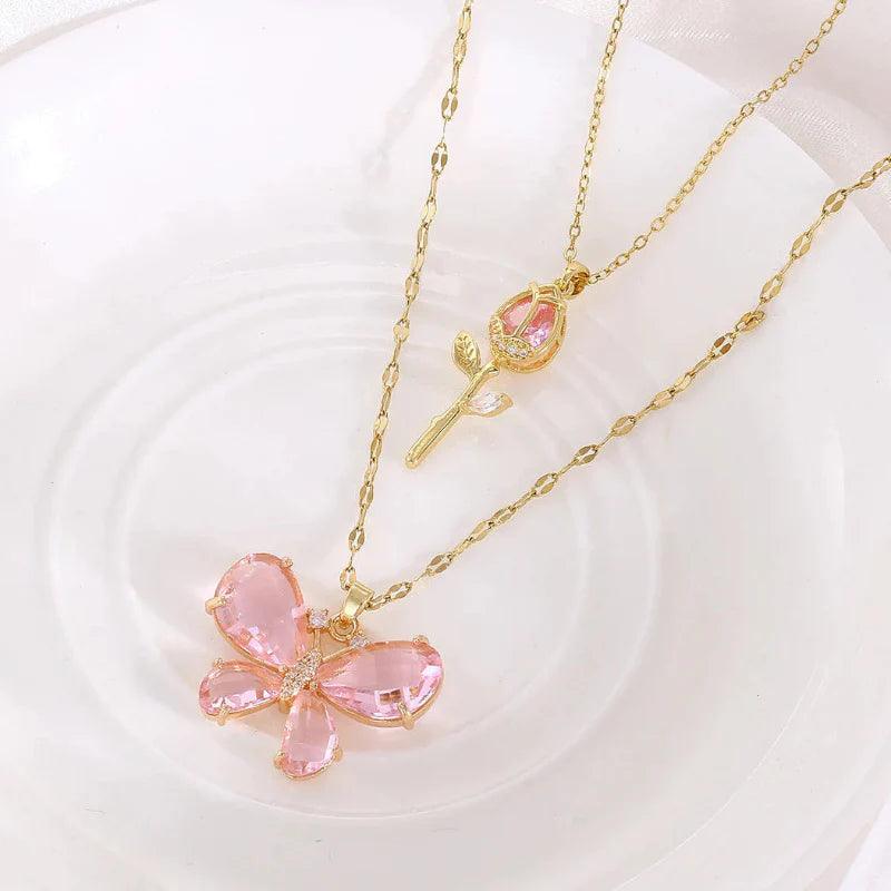 Gold-tone butterfly rose necklace with pink butterfly pendant and rose stem charm