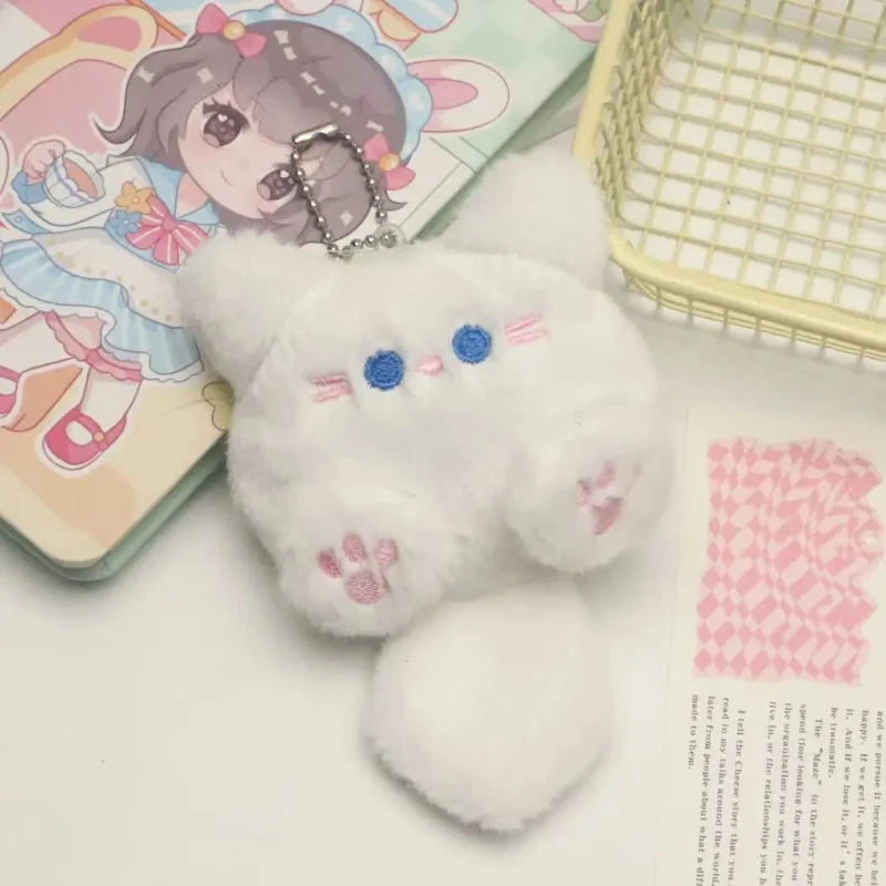 White cat plush keychain with blue eyes and pink paw prints, metal chain