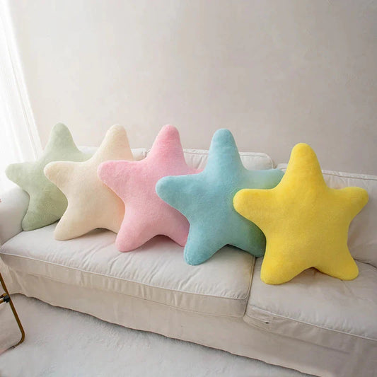 Star-shaped plush pillow set on a couch in pastel colors, five-point star shape.