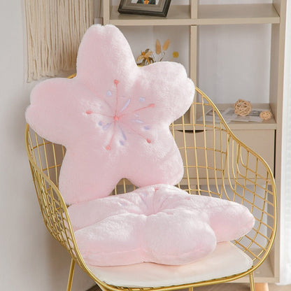 Pink cherry blossom plush pillow on a gold wire chair, embroidered flower stamen