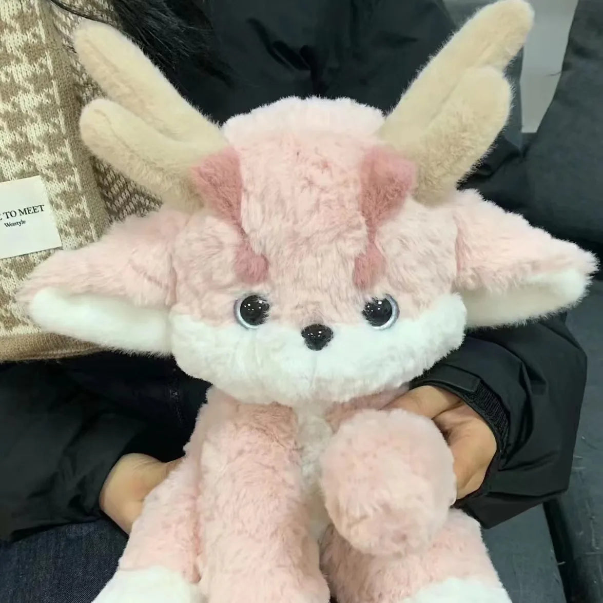 Pink plush dragon with antlers, plush wings spread, white muzzle and black eyes