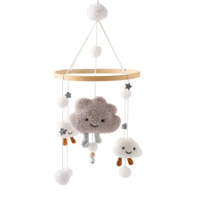 Wooden baby crib mobile with smiling cloud, bear faces, and pom-pom hanging toys