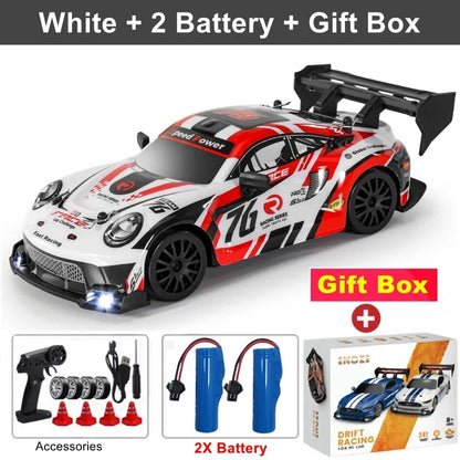 White RC drift racing car with red graphics, black rear wing, 4x4 off-road style