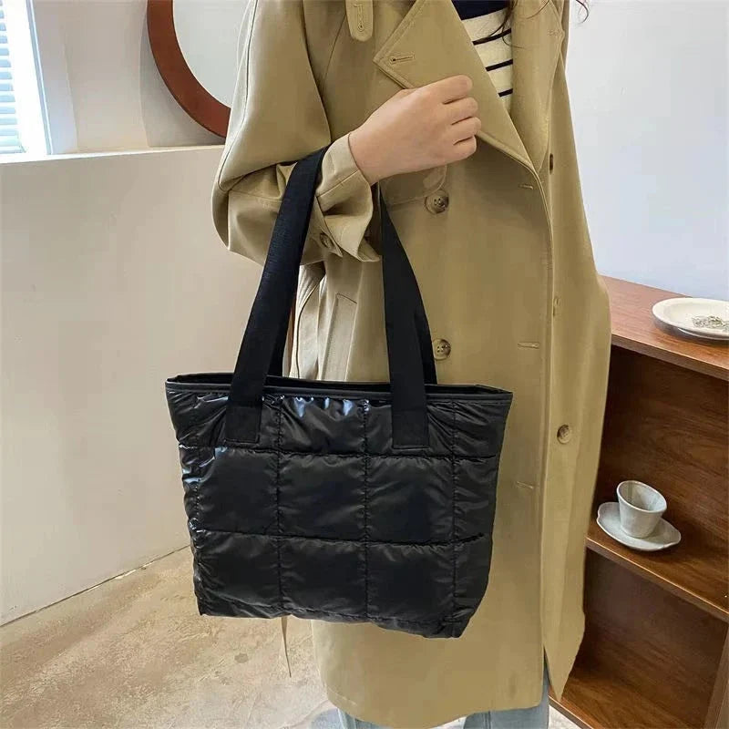 Black quilted cotton tote bag with long handles, open top, padded front panel