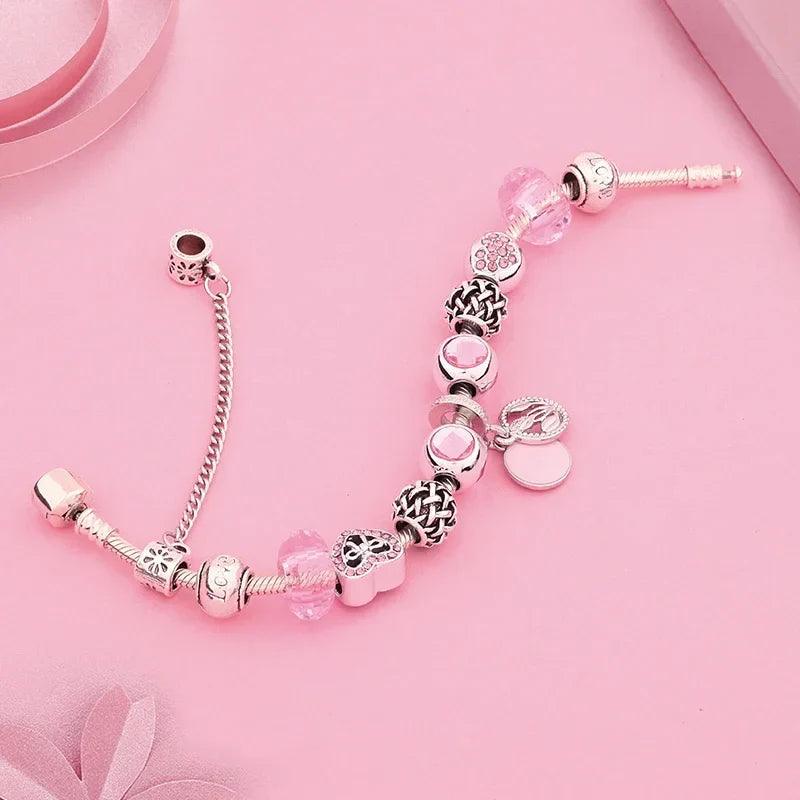 Pink charm bracelet with silver-tone beads, pink heart stones, flower charms, end caps