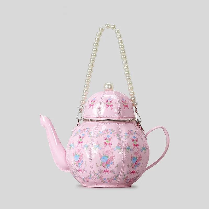 Pink teapot-shaped mini bag with pearl beaded handle and floral pattern