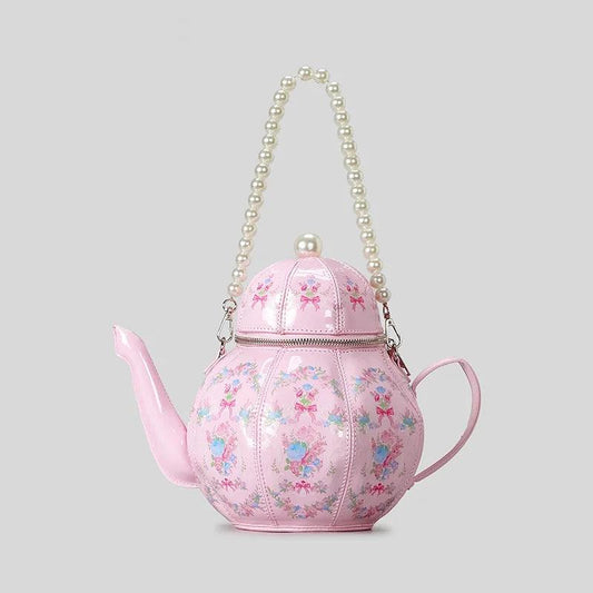 Pink teapot-shaped mini bag with pearl beaded handle and floral pattern