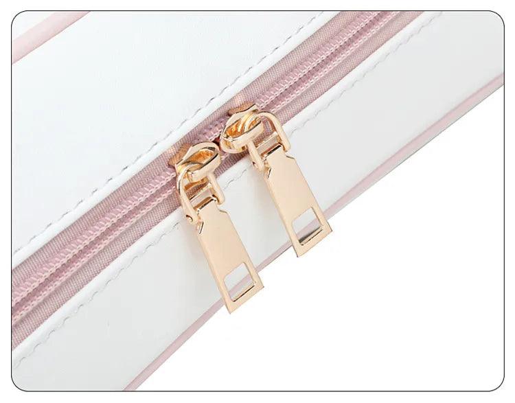 Kawaii messenger bag zipper close-up with dual gold pulls on pale pink trim