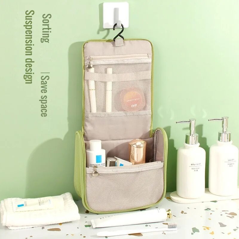Green hanging toiletry organizer with mesh pocket and hanging loop