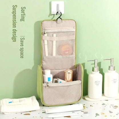 Green hanging toiletry organizer with mesh pocket and hanging loop