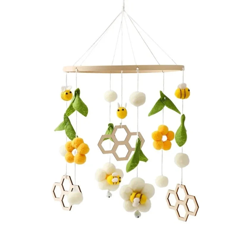 Wooden baby crib mobile with yellow bee, flower, and hexagon hanging charms