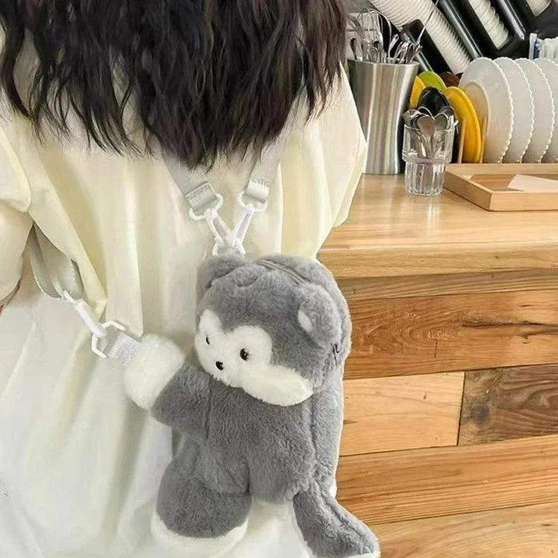 Plush crossbody bag with grey puppy face, cream muzzle, hanging strap