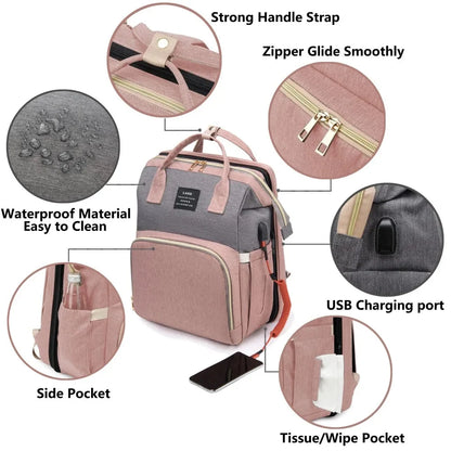 Mauve and gray diaper backpack with zipper, side pockets, and USB charging port