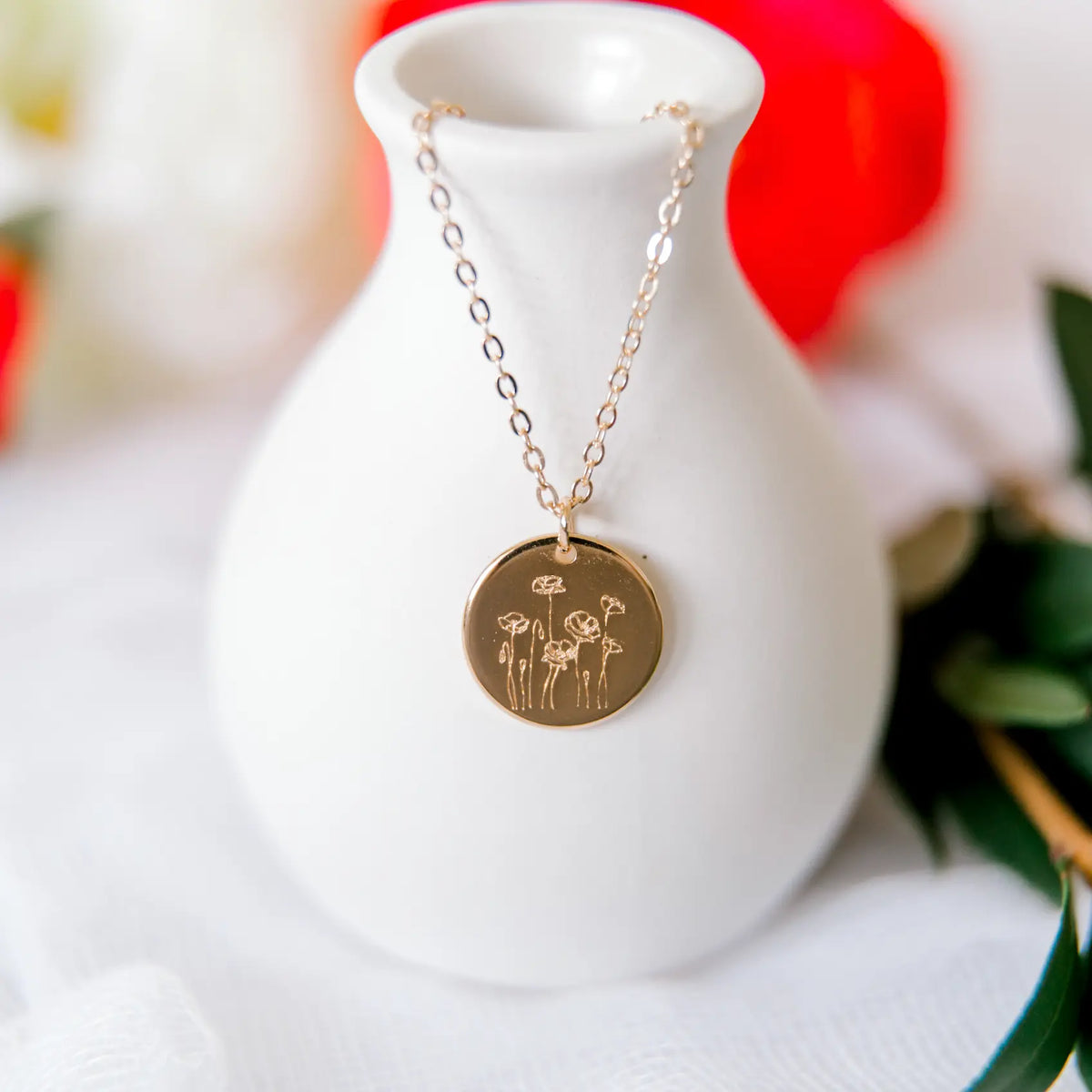 Poppy Necklace with round floral pendant on a fine chain