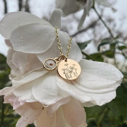 Gold-tone necklace with engraved poppy pendant and mustard seed charm