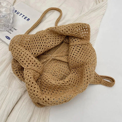 Beige crochet tote bag close-up with folded handles and textured stitch pattern