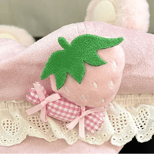 Close-up pink bear hat with green strawberry patch and pink check bow