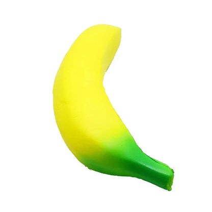 Yellow squishy banana toy on white background, rounded fruit form with green end