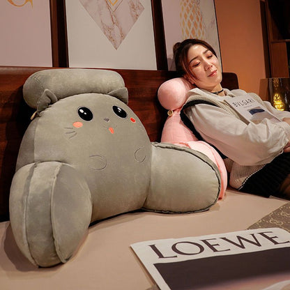 Gray plush animal reading pillow with black eyes, orange nose, and rounded ears