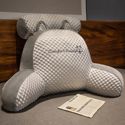 Gray and white plush reading pillow with rounded back and character graphic
