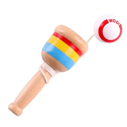 Close-up of striped wooden skill cup toy with red throw ball on string