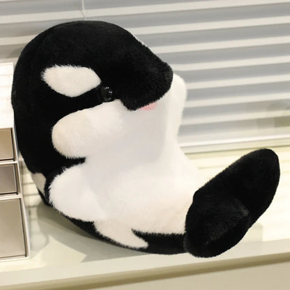 Black dolphin plush with white belly patch, embroidered eye and side fin detail