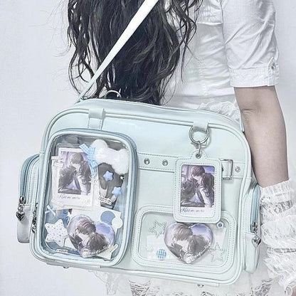 Pastel crossbody bag, light blue, clear front pouch with character-style graphics