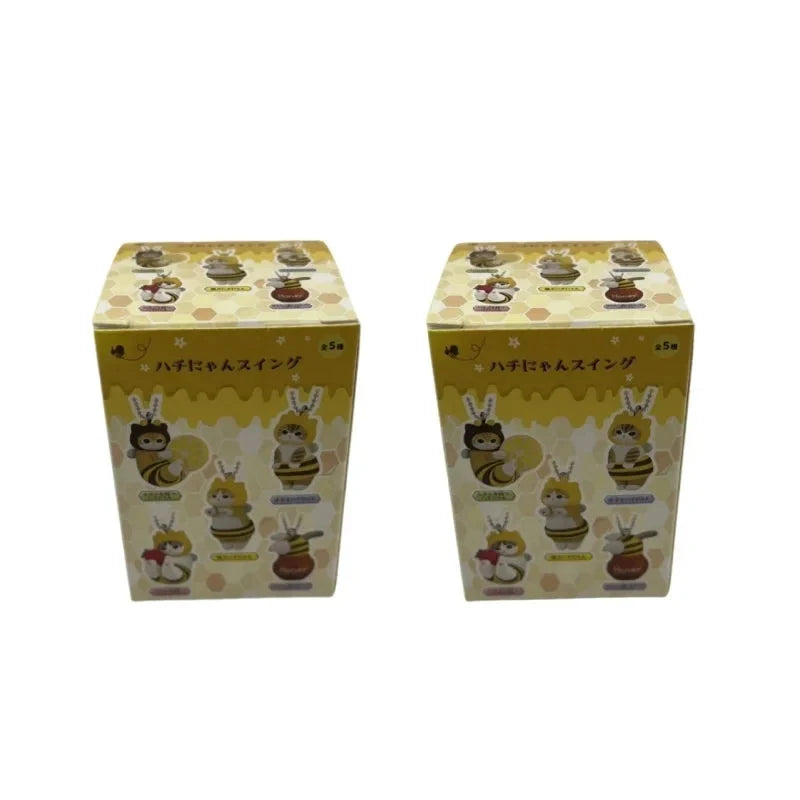Two yellow cube boxes of bee and cat twisted egg anime figure keychains, 5-pack