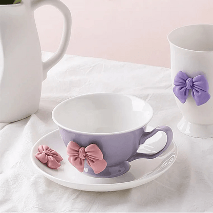 Lilac tea cup and saucer with purple bow decoration and curved handle