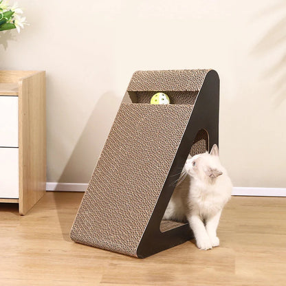 Triangular cardboard cat scratcher with toy ball inside; white kitten sitting by side opening