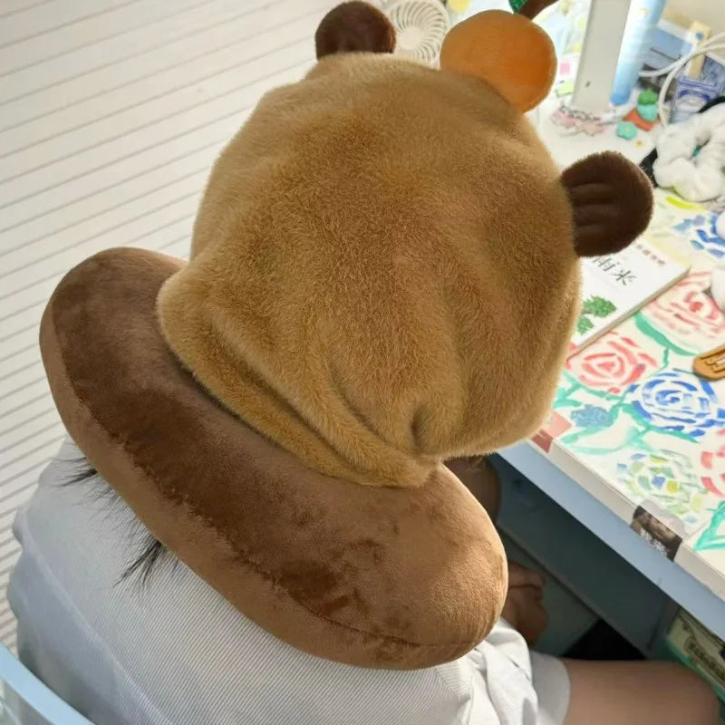 Capybara plush neck pillow hat with brown rounded ears and curved side profile.