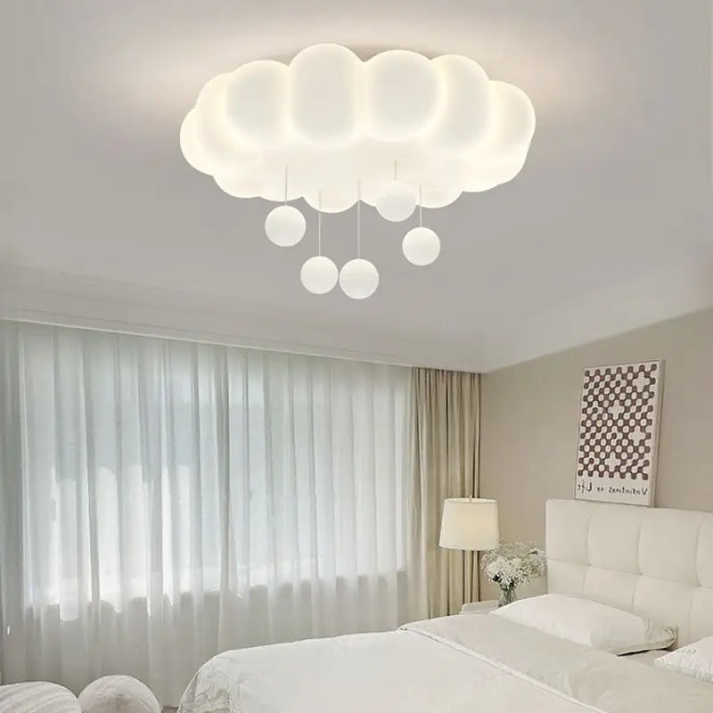 Cloud-shaped ceiling light with glowing white raindrop bulbs
