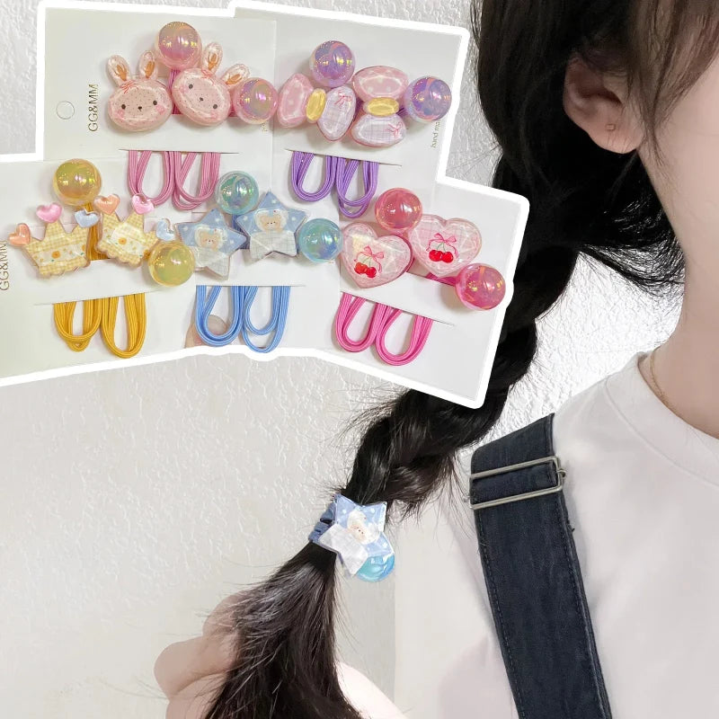 Assorted elastic hair ties with heart and animal charms, shown on a multi-pack card