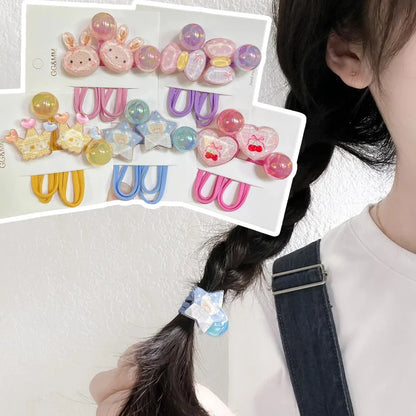 Assorted elastic hair ties with heart and animal charms, shown on a multi-pack card