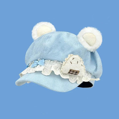 Blue bear hat with white lace trim and stitched bear applique patch