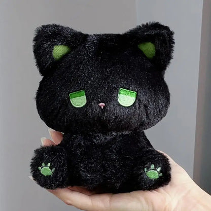 Black plush cat with green sleepy eyes and paw prints, soft stuffed toy
