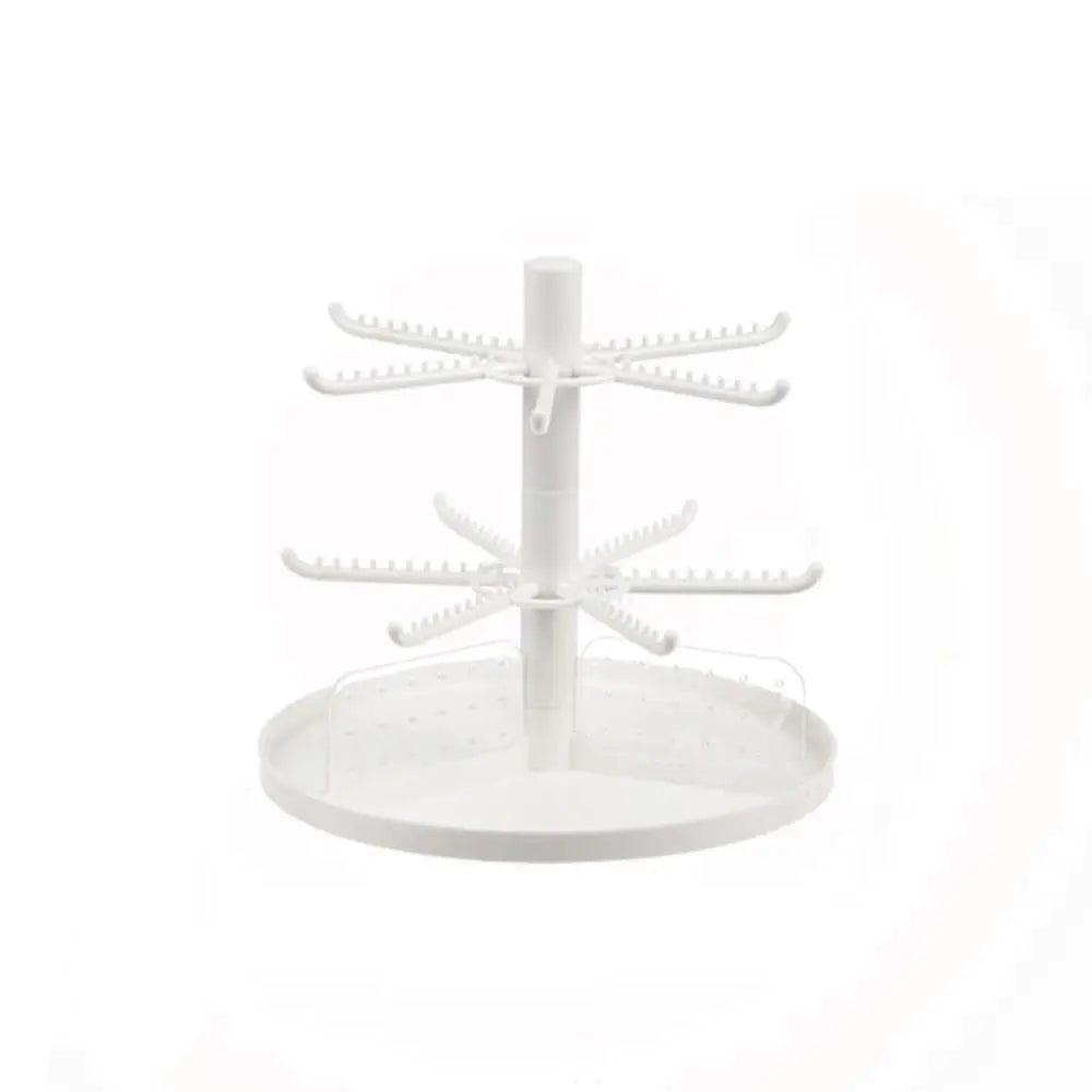 White rotating earring display stand with tiered horizontal hook bars and round base